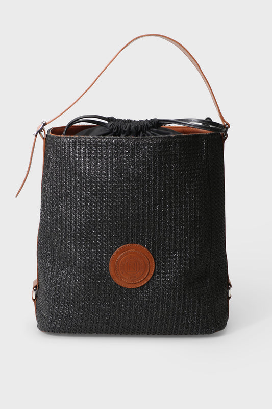 Black woven bucket bag with brown leather accents on a white background