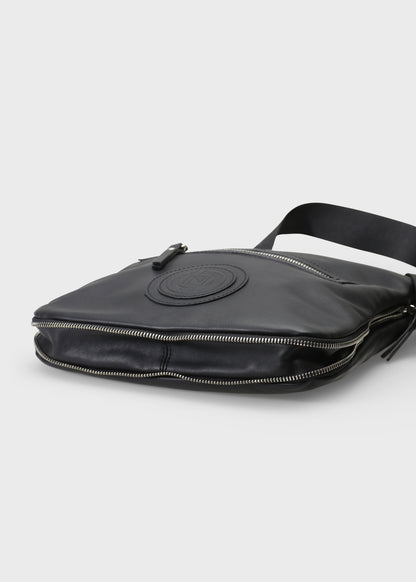 Black leather bag with a visible brand logo on a light gray background